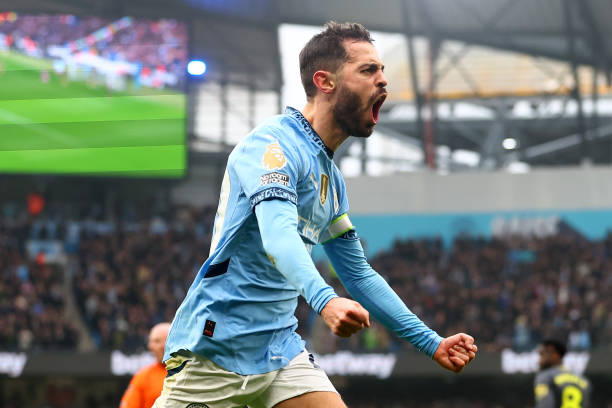 Bernardo Silva of Manchester City celebrates scoring the opening goal during the Premier League match between Manchester City FC and Everton FC at...