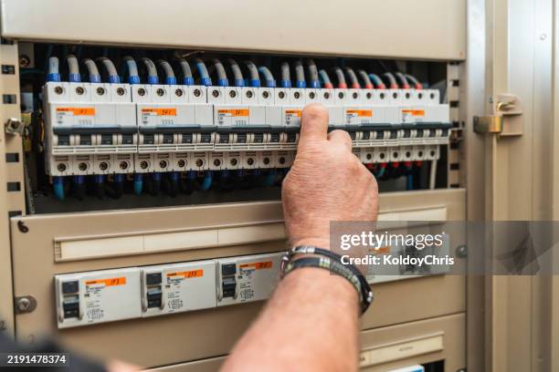 electrician inspecting fuse box in nursing home - apagão imagens e fotografias de stock