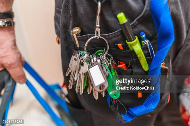 janitor holding keys and tools at work in nursing home - custodian keys stock pictures, royalty-free photos & images