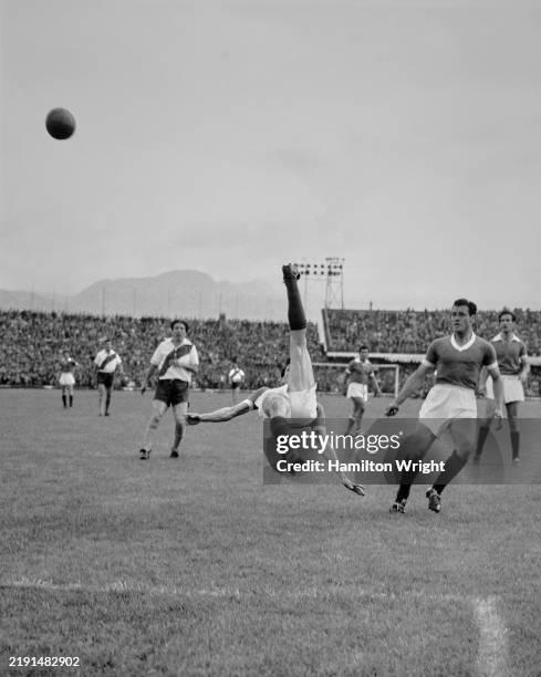 Player performs a bicycle kick during a Categoria Primera A match in Colombia, circa 1950.