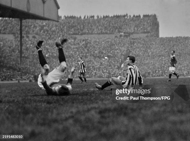 Bradford player lies on his back, his legs in the air, alongside a Newcastle player who sits on the pitch during the FA Cup Final Replay, at Old...