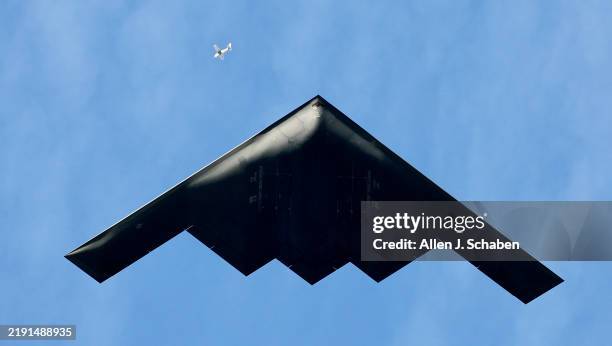 Pasadena, CA A small plane is dwarfed by a Northrop Grumman B-2 Stealth Bomber flying over Colorado Blvd. In Pasadena Wednesday, Jan. 1, 2025. The...