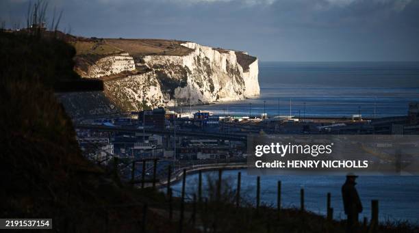 The white chalk cliffs of Dover are seen in the winter sunlight behind the Port of Dover in south-east England on January 2, 2025. Around 36,816...