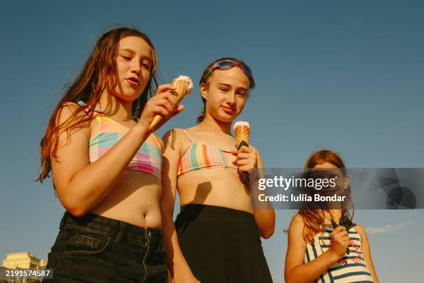 kids enjoying ice cream on a sunny beach day - colour manipulation stock pictures, royalty-free photos & images