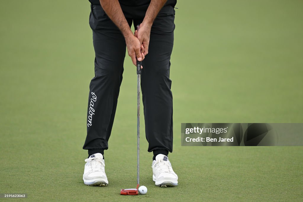 Jason Day of Australia stands over his ball on the 12th green during