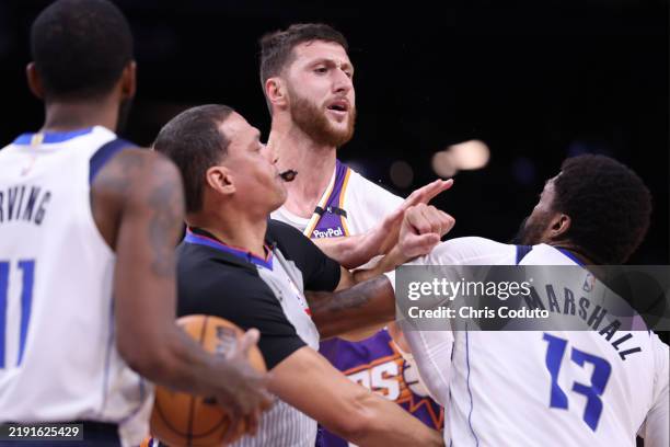 Jusuf Nurkic of the Phoenix Suns and Naji Marshall of the Dallas Mavericks get into an altercation during the second half at Footprint Center on...
