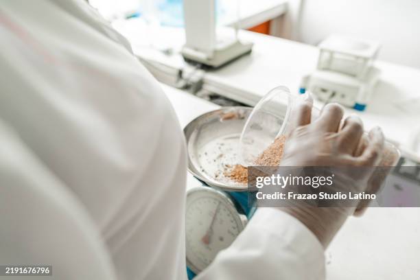 close-up of a scientist putting scientific experiment on weight scale on a laboratory - laboratory scale stock pictures, royalty-free photos & images
