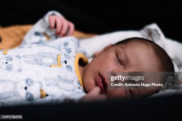 newborn baby sleeping peacefully in his carriage. - baby diaper sleeping stock pictures, royalty-free photos & images