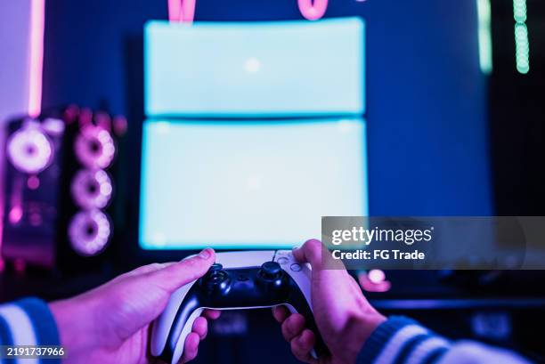 man's hands playing with game controller on computer at home - point of view - first person stock pictures, royalty-free photos & images