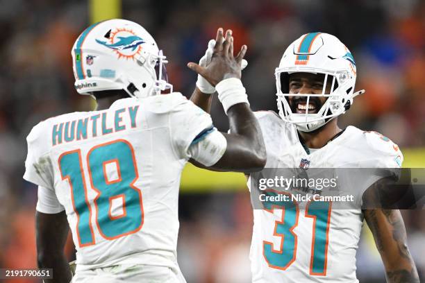 Tyler Huntley of the Miami Dolphins celebrates a touchdown with Raheem Mostert during the third quarter against the Cleveland Browns at Huntington...