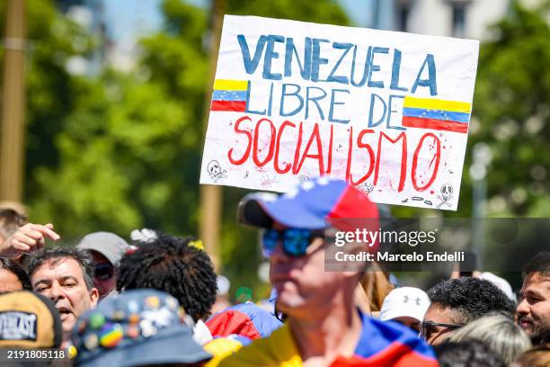 Supporters of opposition leader Edmundo Gonzalez attend outside Casa Rosada with signs against Socialism during an official visit of Venezuelan...