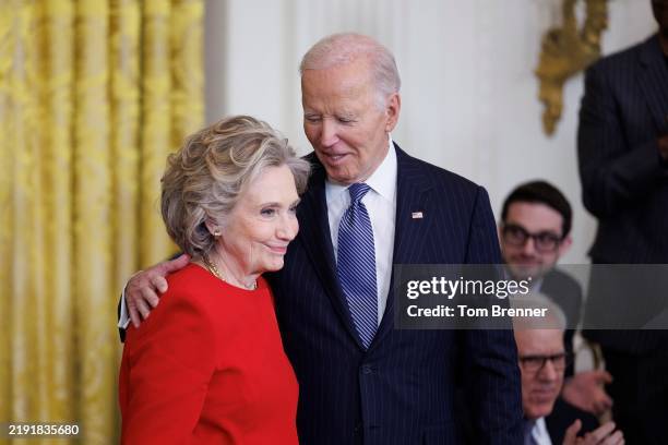 Former U.S. Secretary of State Hillary Clinton greets U.S. President Joe Biden before being awarded the Presidential Medal of Freedom in the East...