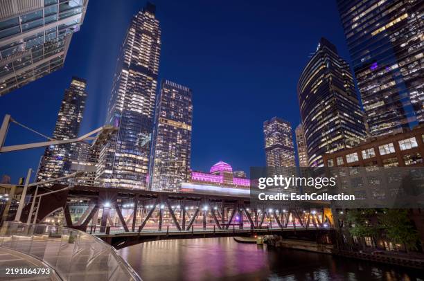 illuminated downtown of chicago with metro train crossing lake street bridge and chicago river at dusk. - elevated train stock pictures, royalty-free photos & images