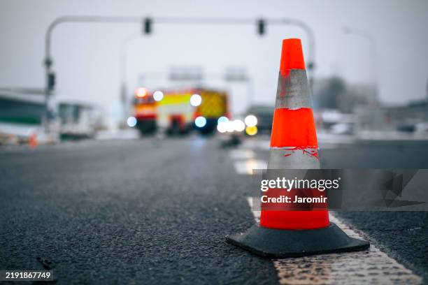 warning traffic cone on road against car accident - olycka bildbanksfoton och bilder