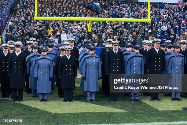 Army Cadets and Navy Midshipmen sing the national anthem before a game between Navy and Army at Northwest Stadium on December 14, 2024 in Landover,...