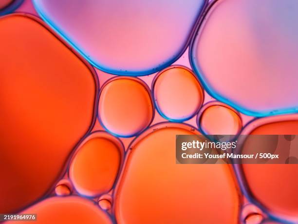 full frame shot of multi colored liquid - cellule photos et images de collection