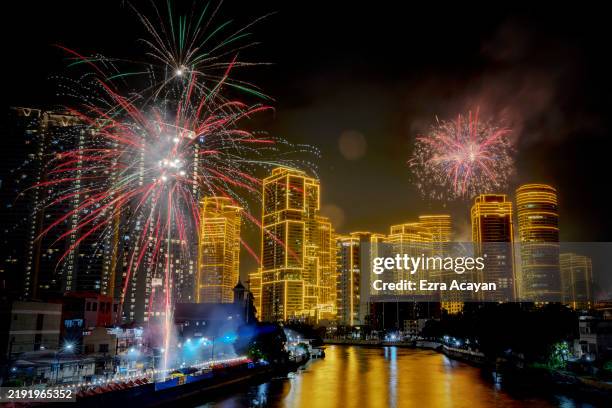 Fireworks explode over skyscrapers during New Year celebrations on January 01, 2025 in Makati, Metro Manila, Philippines.