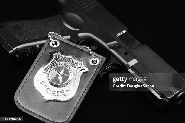 badge and handgun, police service gear - police badge stock pictures, royalty-free photos & images