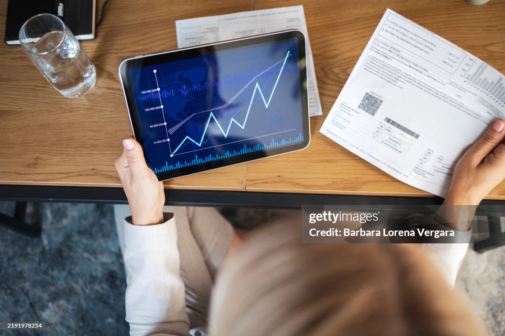Professional analyzing sales growth data on digital tablet