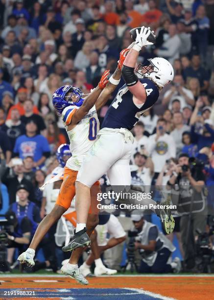 Tyler Warren of the Penn State Nittany Lions catches a pass for a touchdown over Ty Benefield of the Boise State Broncos during the third quarter in...