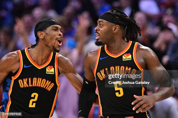 Shai Gilgeous-Alexander and Luguentz Dort of the Oklahoma City Thunder celebrate during the second half against the Boston Celtics at Paycom Center...