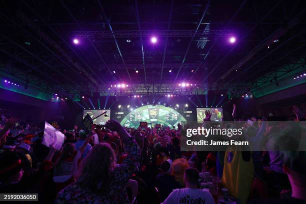 General view of the inside of Alexandra Palace as spectators react as Michael van Gerwen of the Netherlands throws against Callan Rydz of England...