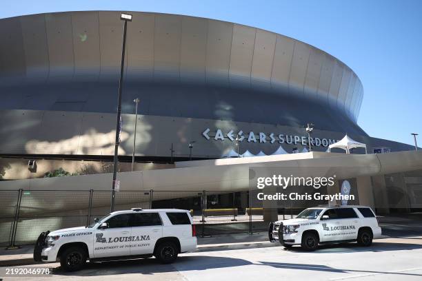 Police vehicles are seen outside the Louisiana Superdome after at least ten people were killed on Bourbon Street when a person allegedly drove into a...
