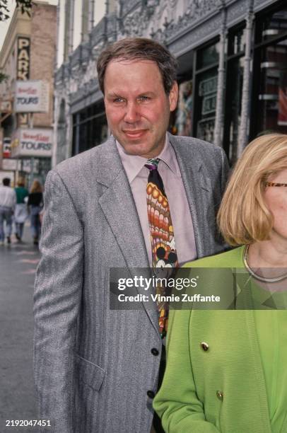 American media executive Michael Eisner, wearing a grey blazer over a pale pink shirt and a 'Mickey Mouse' tie, attends the Hollywood premiere of...