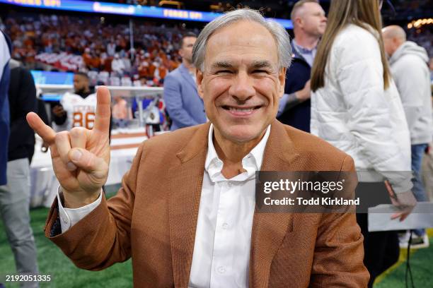 Texas Governor Greg Abbott poses on the field prior to the Chick-fil-A Peach Bowl between the Texas Longhorns and Arizona State Sun Devils at...