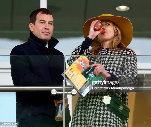 Peter Phillips and Harriet Sperling watch the racing as they attend the New Year's Day Racing Meet at Cheltenham Racecourse on January 1, 2025 in...
