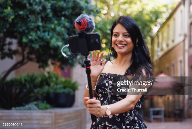 female indian travel influencer recording content - side hustle stock pictures, royalty-free photos & images