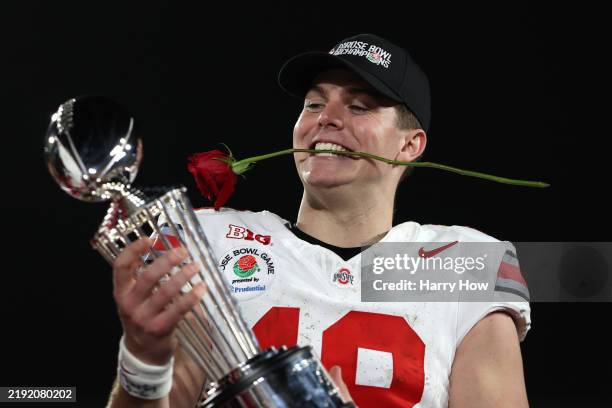Will Howard of the Ohio State Buckeyes holds the Leishman Trophy after defeating the Oregon Ducks 41-21 in the Rose Bowl Game Presented by Prudential...