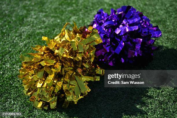 Purple and gold pompoms are placed on the ground before the Tony the Tiger Sun Bowl game between the Louisville Cardinals and the Washington Huskies...