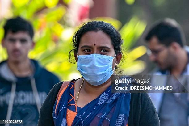 Woman wearing a face mask walks outside a hospital, in Bengaluru on January 6 amid concerns and alleged media reports stating that the Indian Council...