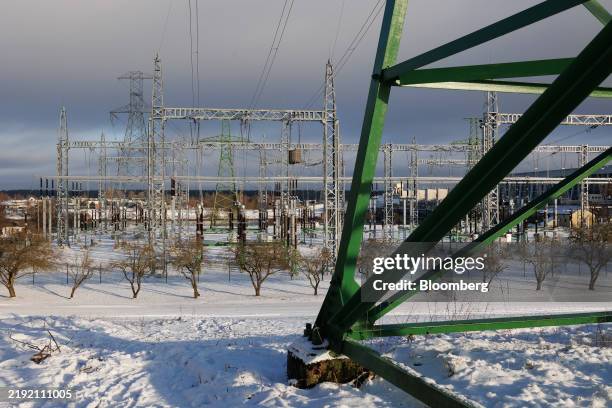 Electrical power lines and transmission towers in snow outside Riga, Latvia, on Saturday, Jan. 1, 2025. The Nordic Investment Bank and Latvian...