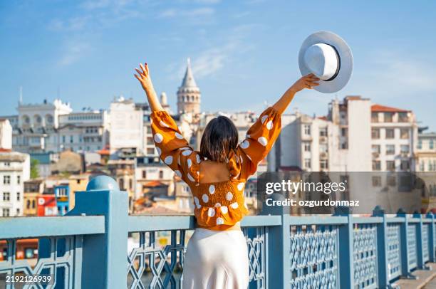 young traveler woman posing on galata bridge, while exploring istanbul - istanbul province stock pictures, royalty-free photos & images