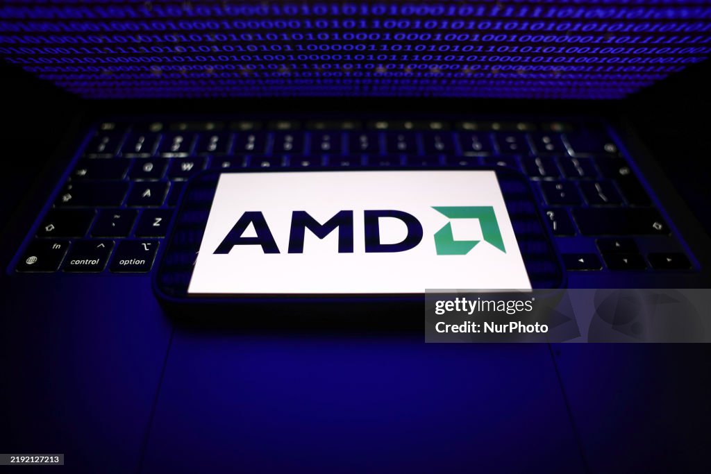 Binary code displayed on a laptop screen and AMD logo displayed on a ...