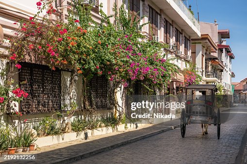 Scenic Cobblestoned Street with Spanish Colonial Architecture and Flowers in Vigan, Philippines Scenic Cobblestoned Street with Spanish Colonial Architecture and Flowers in Vigan, Philippines