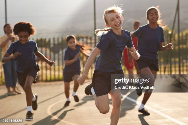 happy girl running race on sports day - physical education stock pictures, royalty-free photos & images