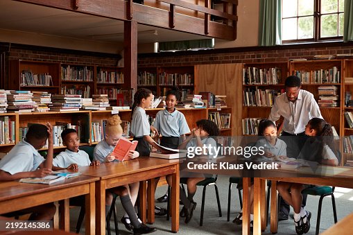 Elementary students studying in library Elementary students studying in library
