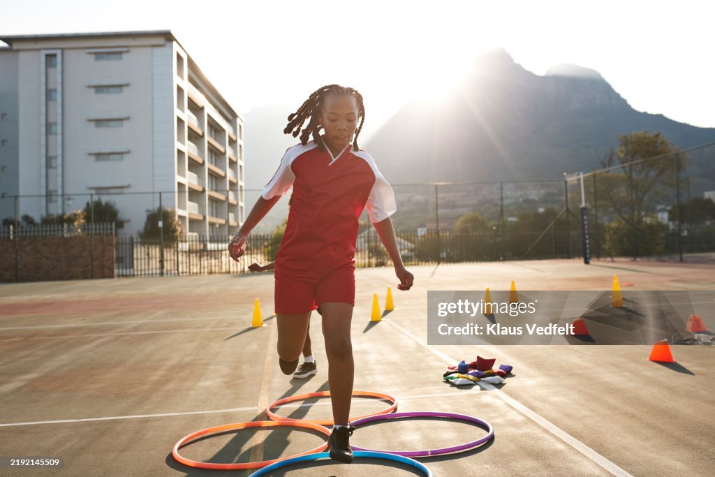 Jumping In Hoops Girl Jumping In Hula Hoops At Schoolyard High-Res Stock Photo - Getty ...