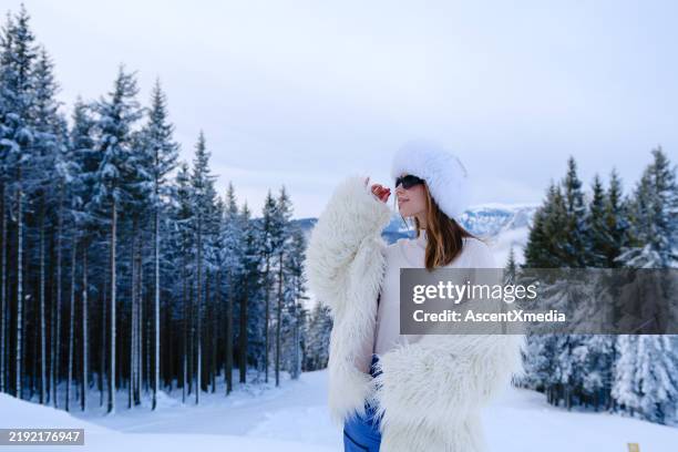 portrait of beautiful young woman in luxury apres ski wear - skier portrait stock pictures, royalty-free photos & images