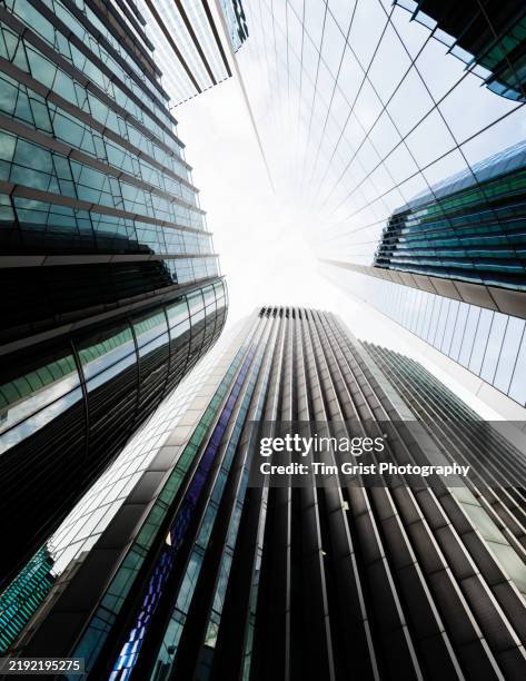 directly below view of modern skyscrapers - venture capital stock pictures, royalty-free photos & images
