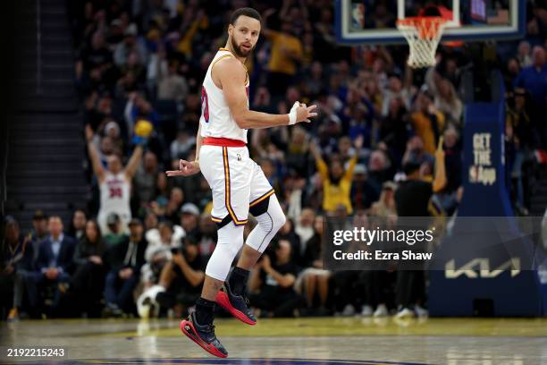 Stephen Curry of the Golden State Warriors reacts after he made a three-point basket against the Philadelphia 76ers during the second half at Chase...