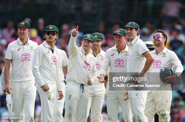 Pat Cummins of Australia looks on with teammates during a successful DRS review to dismiss Washington Sundar of India during day one of the Fifth...