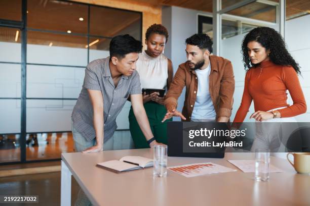 team huddle around the laptop - four people stock pictures, royalty-free photos & images