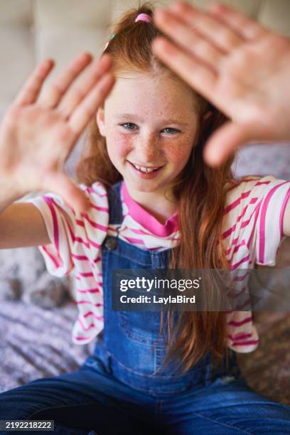 framed by joy: girl with hands outstretched - innocence stock pictures, royalty-free photos & images
