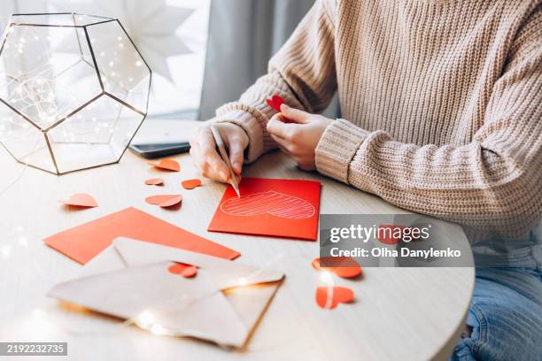 young woman writing a valentine card - love letter stock pictures, royalty-free photos & images