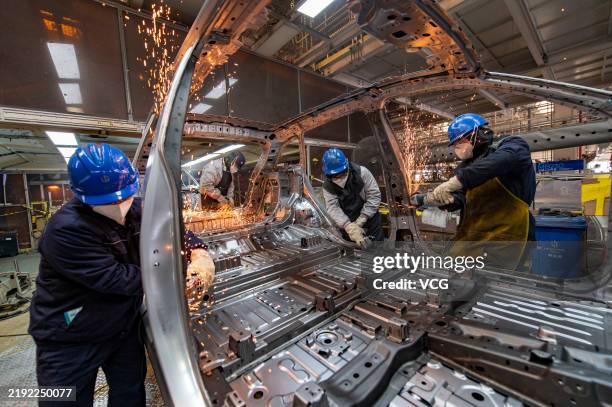 Employees assemble new energy vehicles at an intelligent factory of electric vehicle enterprise Leapmotor on January 3, 2025 in Jinhua, Zhejiang...