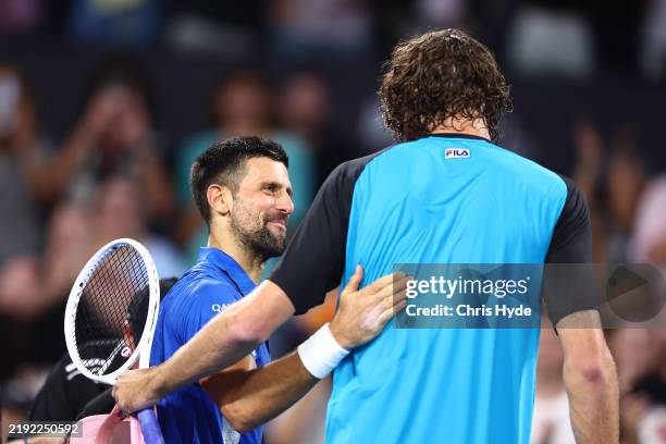 Novak Djokovic of Serbia and Reilly Opelka of the USA after their quarter-final match during day six of the 2025 Brisbane International at Pat Rafter...
